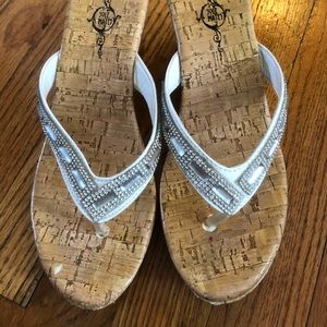 White wedge sandals with rhinestone accents
